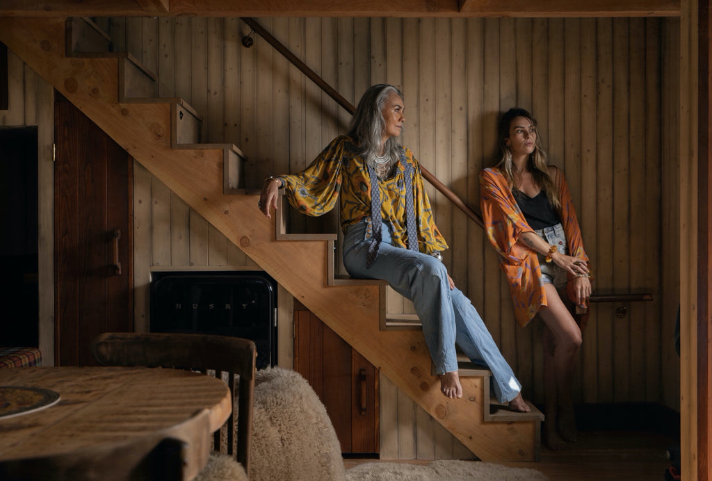 Women in bespoke design kaftan and blouse standing on stairs