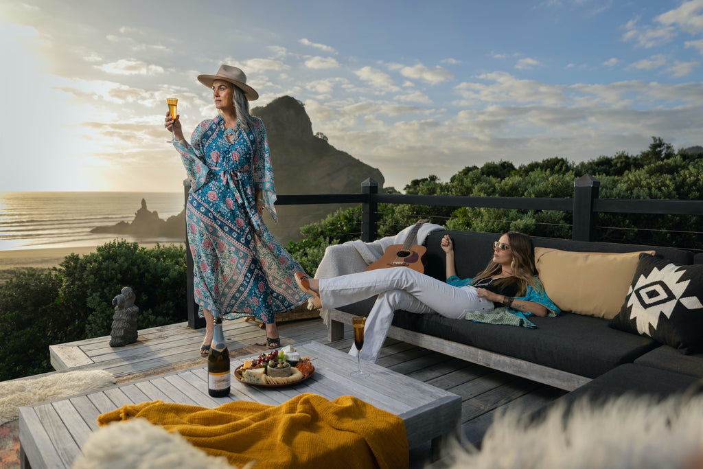 women relaxing in bohemian beach vibes - kimono and kaftans on decking